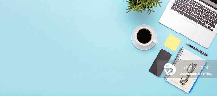 Stylish table desk, workspace on blue background