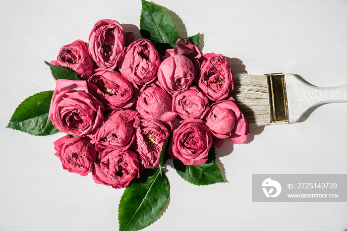 Paint brush drawing with pink flowers on white background. The concept of spring and international w