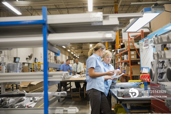 Workers examining inventory in warehouse