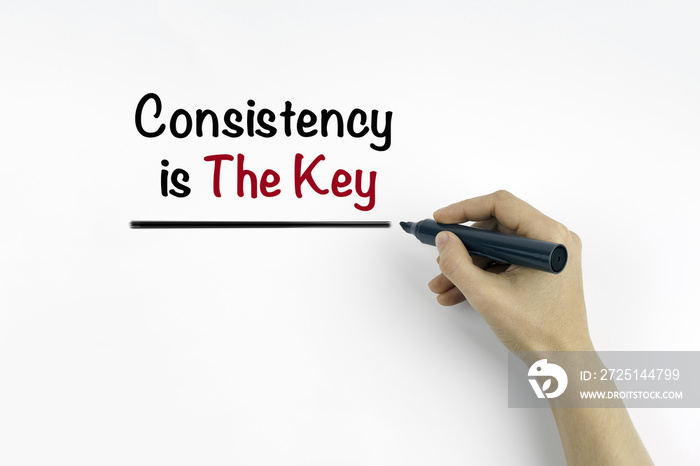 Hand with marker writing: Consistency is The Key