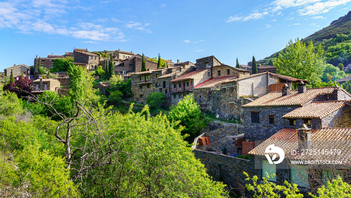 Aerial view of old town in the mountains with stone houses and green trees. Patones de Arriba Madrid