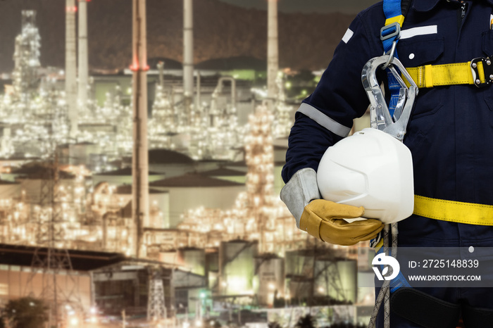 Industrial worker working at height equipment wearing safety harness and safety line working.