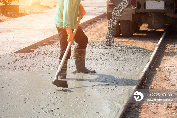 Workers pouring concrete with a cement mixer truck