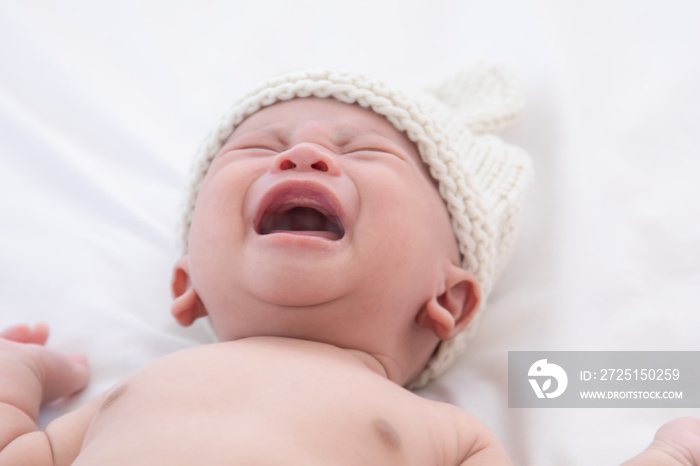 Newborn baby crying sick fever, get flu check up at clinic, Asian child infant 0-1month fussy scream