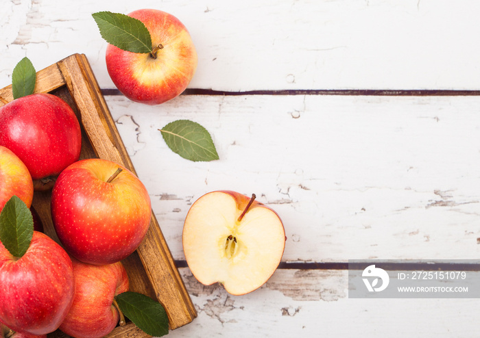 Red organic healthy apples in vintage box on wooden background. Space for text