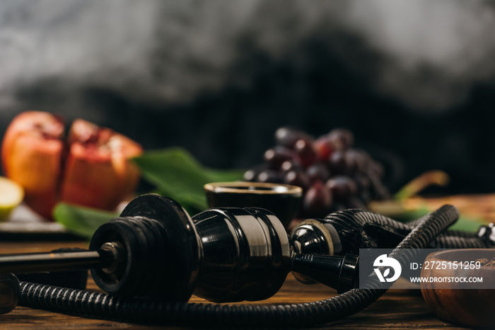 selective focus of fresh fruits and hookah on wooden surface