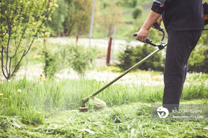 Cutting grass with a professional grass trimmer