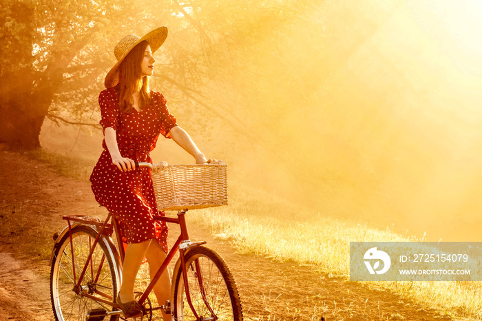 Girl on a bike in the countryside in sunrise time