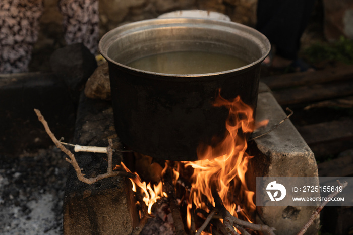 The cauldron over the wood fire