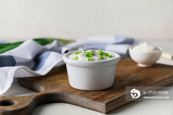 Bowl of tasty sour cream on table