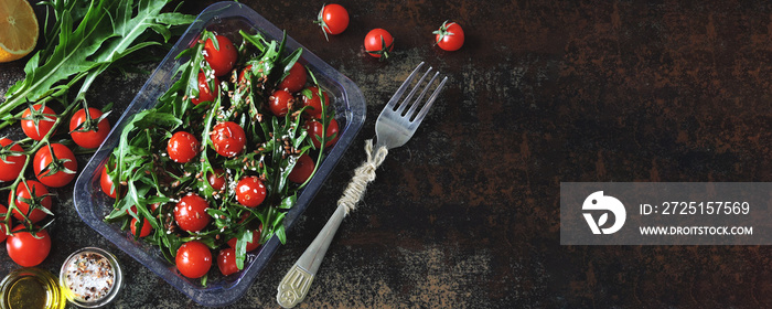 Healthy salad in the lunchbox. Arugula salad and cherry tomatoes with seeds to go. Keto diet Banner.