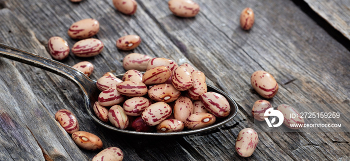 Pinto beans on an old wooden table