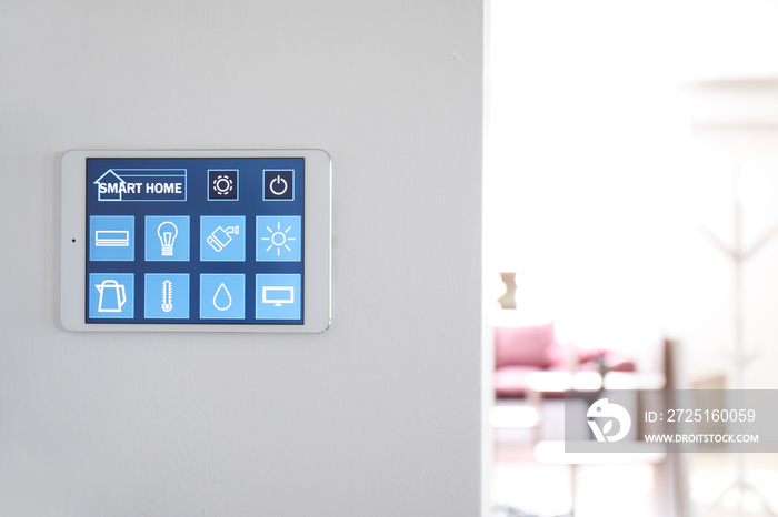 Tablet computer with smart home application on wall