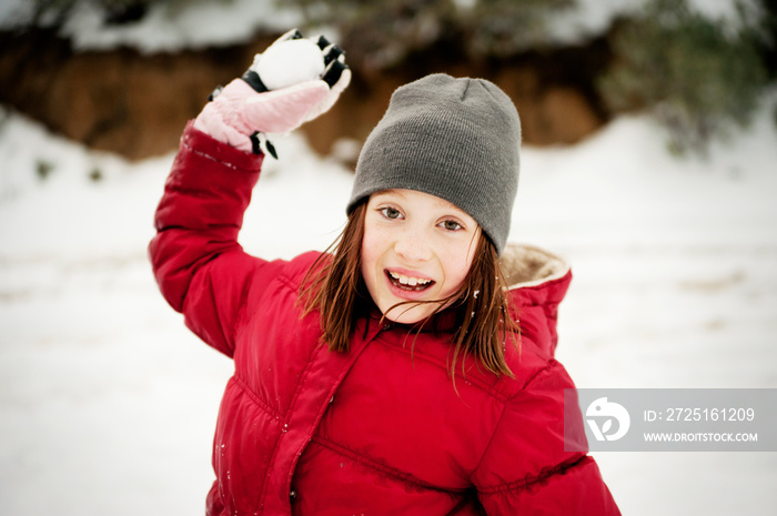 Portrait of girl playing with snow