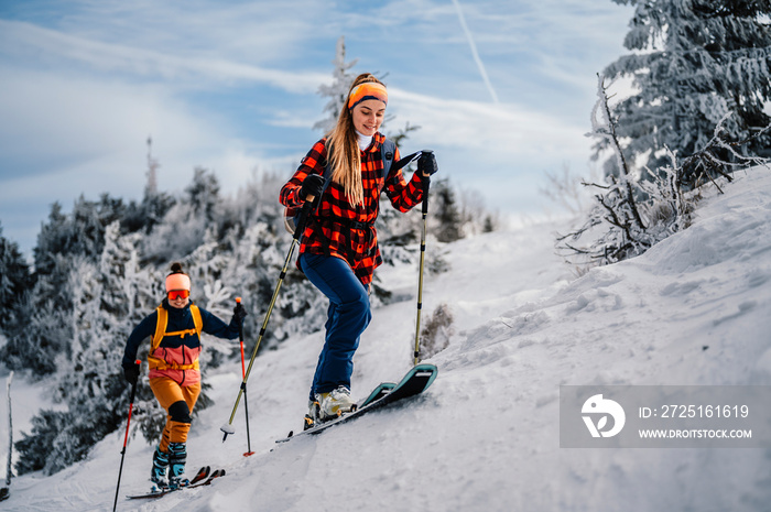 Mountaineer backcountry ski walking ski woman alpinist in the mountains. Ski touring in alpine lands