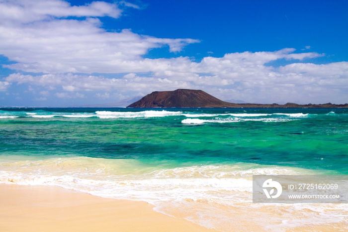 View from Corralejo (Fuerteventura) over white sand beach on turquoise water of atlantic ocean with 