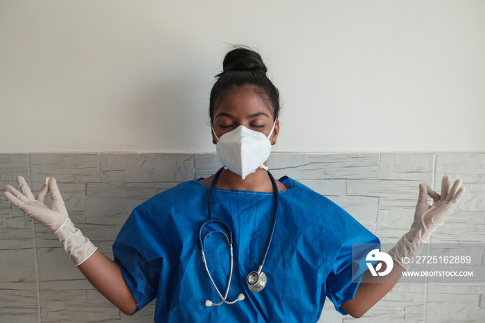 A tired, stressed out African-American nurse meditates on her time out