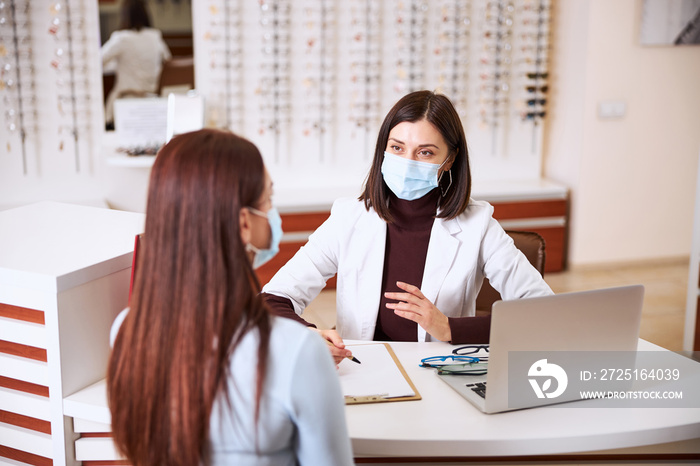 Optician informing the customer about the check results