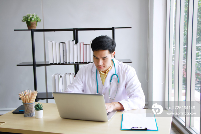 Smiling Professional asian male psychiatrist is studying and researching for treatment Mental health