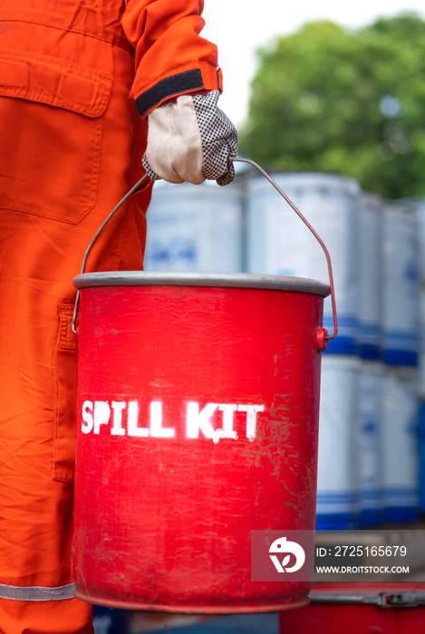 A rescue team is holding red box of  Spill kit , ready to response on chemical spilling accident. In