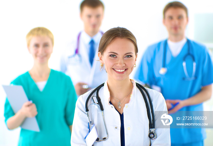 Attractive female doctor in front of medical group