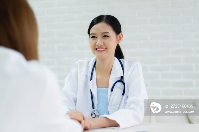 Female doctor talking to patient.Doctor and patient discussing something while sitting at the table 