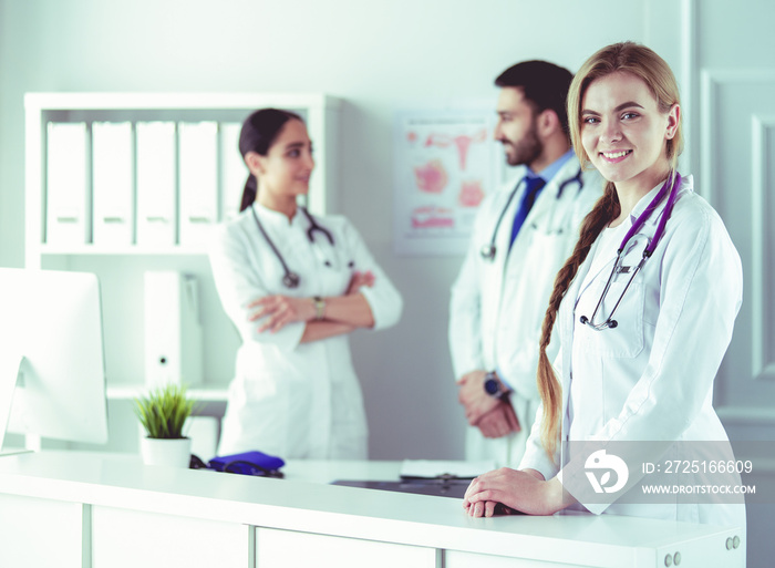 Attractive female doctor in front of medical group