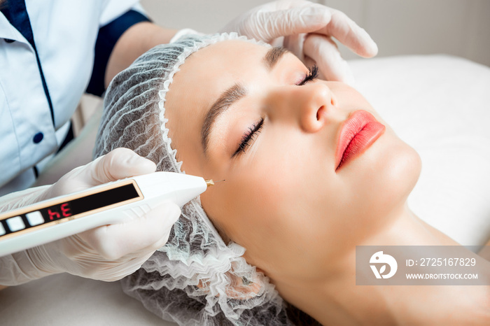 The doctor cosmetologist makes the Rejuvenating facial injections procedure for tightening and smoot