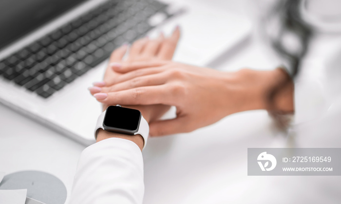 Unrecognizable girl checking time on her wristwatch