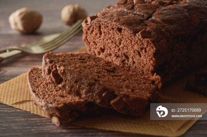 Piece of chocolate cake , fudge or pound cake. Wooden background.