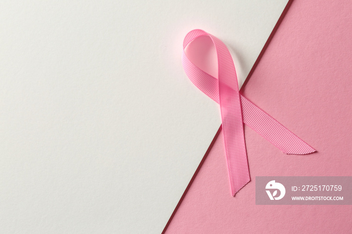 Pink ribbon on color background. Breast cancer awareness concept