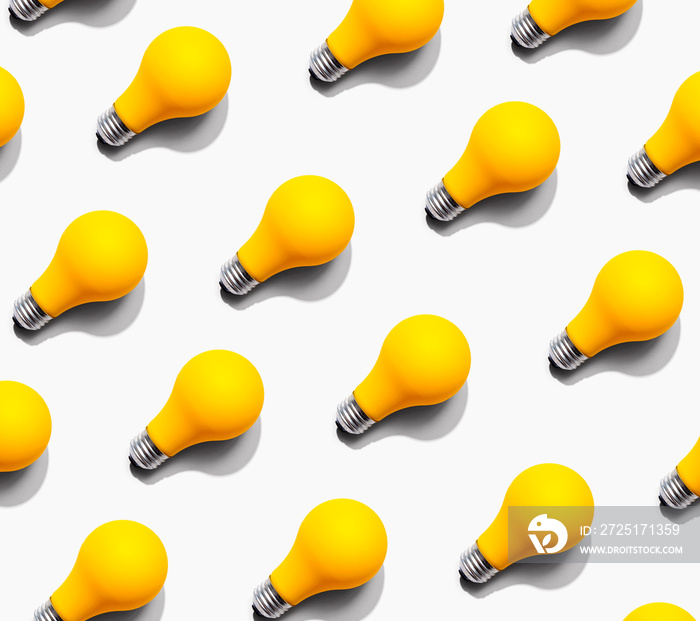 Yellow light bulb pattern with shadow - flat lay