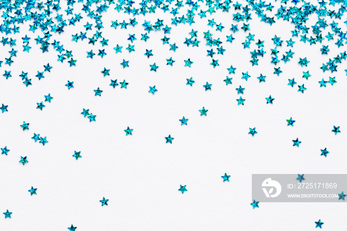 Iridescent Blue color falling stars. Glitter confetti on white festive background. Holiday Sparkling