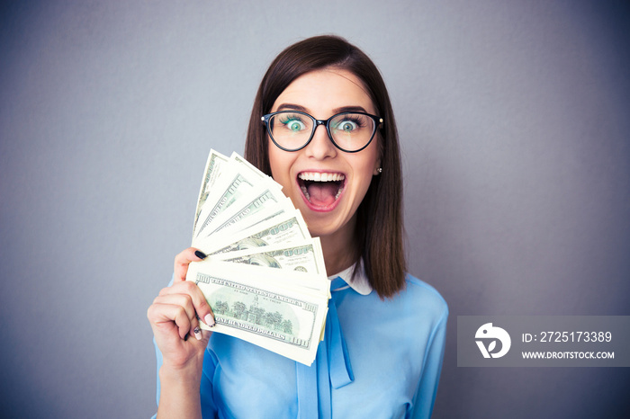 Businesswoman holding bill of dollars and shouting