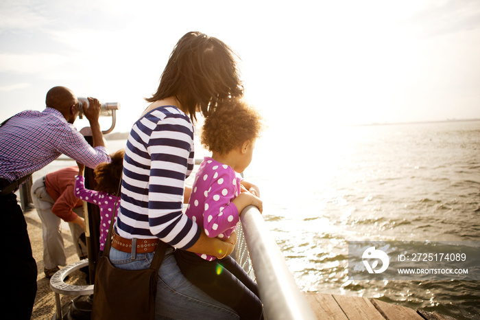 Parents and daughters (2-3, 4-5) on riverbank