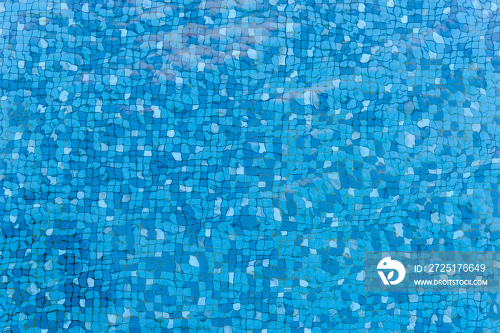 Top view of water ripples on blue mosaic tiled. bottom of swimming pool. background