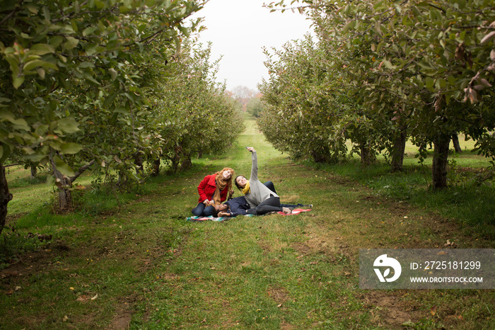 Friends making selfie in orchard