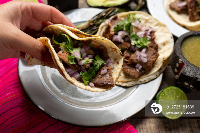 Grilled beef steak tacos on wooden background. Mexican food