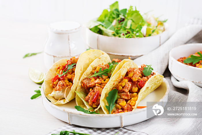 Mexican tacos with chicken meat, corn and tomato sauce. Latin American cuisine. Taco, tortilla, wrap
