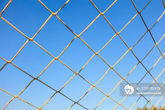 Football net on blue sky background