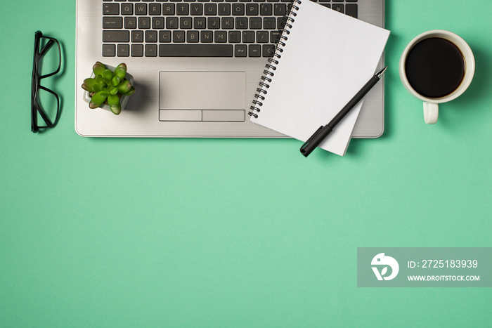 Top view photo of flowerpot pen and planner on grey laptop keyboard glasses and cup of coffee on iso