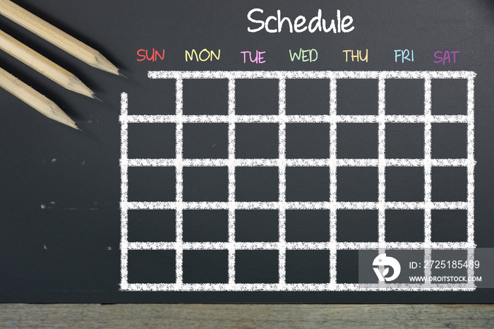 Schedule with grid time table on black chalkboard background