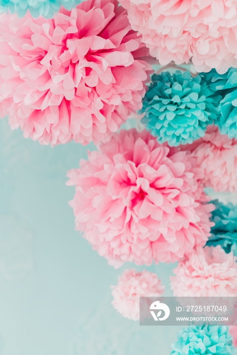 blue and pink pom-poms on background brick wall