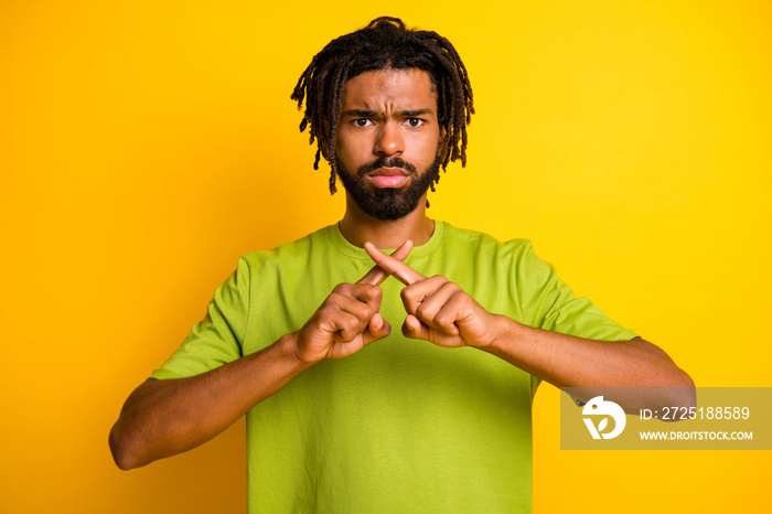 Photo of serious afro american guy cross index fingers stop block signal isolated over bright yellow