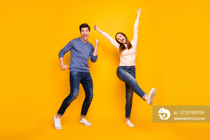 Full body photo of excited funny couple relax rest feel content raise hands wear trendy modern outfi