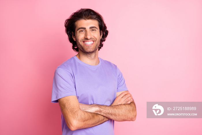 Photo of happy positive young man crossed arms beaming smile isolated on pink color background