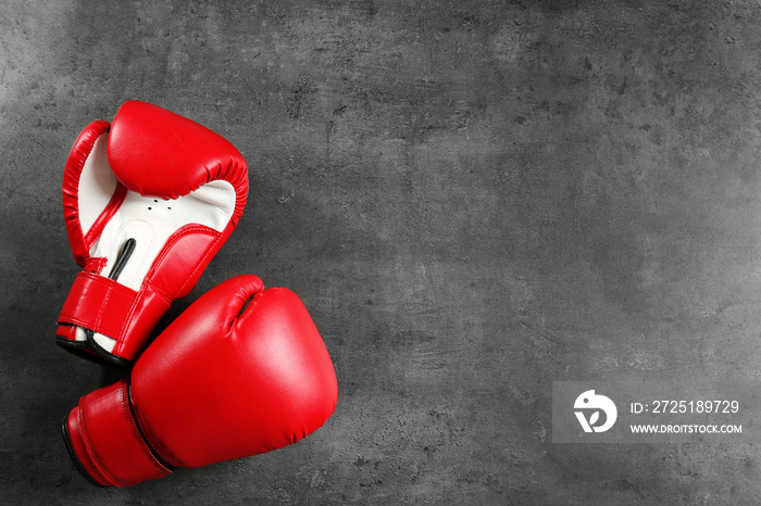 Boxing gloves with blank space for gym exercise plan on grey background. Flat lay composition