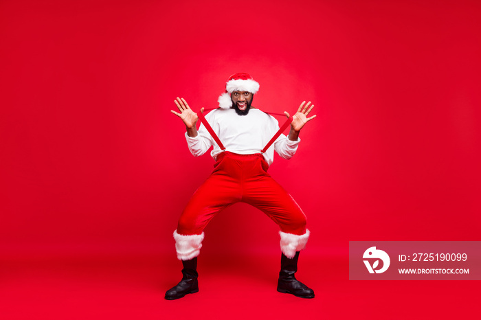 Full length photo of cheerful afro american santa with white sweater touching suspenders fooling wea