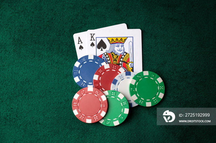 Stack of chips and two aces on the table on the green baize - poker game concept