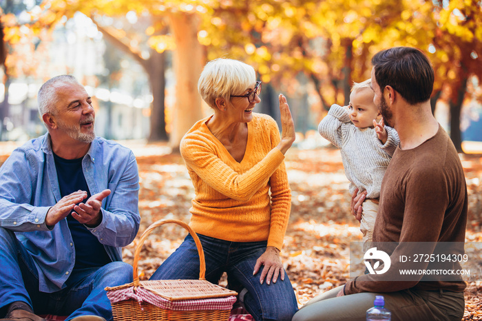 Multl generation family in autumn park having fun